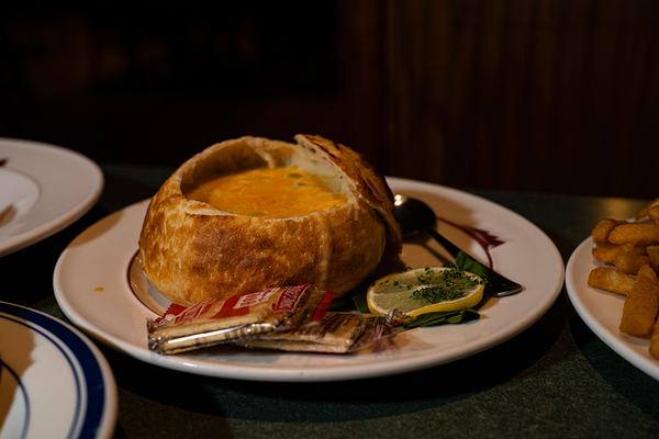 Soup in a bread bowl with a sandwich